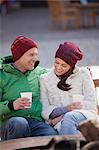 Couple sitting and enjoying warm drinks outside