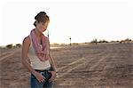 Young woman standing in desert, portrait