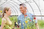 Mature man and mid adult woman shopping in garden centre