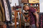 Young man looking into cabinet in vintage shop