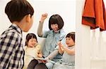 Mother and children laughing at storybook