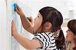 Close up portrait of female toddler having fun drawing