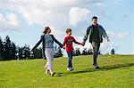 Parents and son walking hand in hand