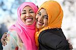 Close up portrait of two young woman in park