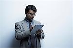 Studio portrait of businessman with digital tablet