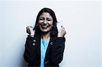 Studio portrait of businesswoman laughing