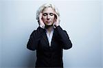 Studio portrait of businesswoman with hands on face