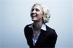 Studio portrait of businesswoman laughing