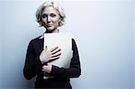 Studio portrait of businesswoman holding file