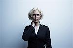 Studio portrait of businesswoman with hand on neck