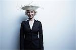 Studio portrait of blond businesswoman wearing straw hat