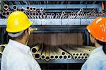 Close up of two warehouse workers in front of shelves