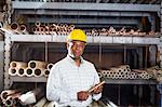 Man in warehouse with copper pipe