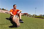 Young man taking a break on sport stadium grass