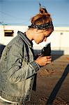 Woman looking at vintage camera