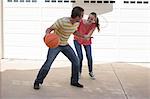 Brother and sister playing basketball