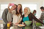 Grandchildren with grandmother photographing themselves