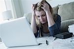 Stressed young woman with hands in hair