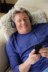 Mature man wearing headphones, smiling