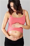 Pregnant woman touching stomach