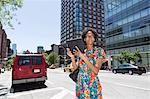 Woman on street parking bay holding digital tablet