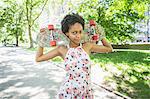 Woman carrying skateboard across shoulders