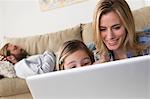 Mother and daughter looking at laptop