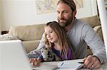 Father with child using laptop