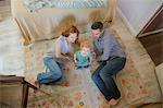 Couple lying on floor with child