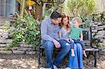 Husband & wife smiling at child