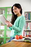 Woman smiling at digital tablet