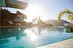 Sun over mountains and swimming pool