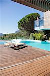 Woman on balcony above swimming pool