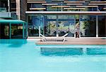 Woman at doorway of patio and swimming pool