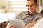 Portrait of smiling man using digital tablet