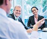 Smiling business people meeting in conference room