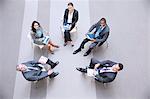 High angle portrait of smiling business people meeting in circle