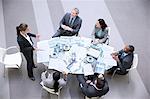 High angle view of gesturing businesswoman leading meeting