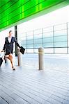 Businesswoman running with suitcase