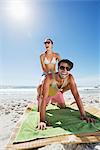 Enthusiastic couple piggybacking on beach