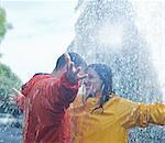 Happy couple dancing in rain