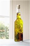 Still life of bottle of olive oil with herbs on window sill, Germany