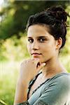 Close-up portrait of teenaged girl outdoors in nature, looking at camera, Germany