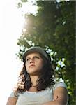 Close-up portrait of teenaged girl wearing cap outdoors, looking into the distance, Germany