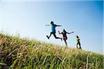 Girls running up hill, Germany