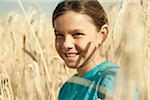 Close-up portrait of girl standing in wheat field, Germany
