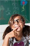 Close-up portrait of girl sitting at desk in classroom, Germany