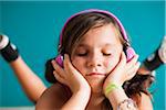 Close-up portrait of girl wearing headphones with eyes closed, Germany