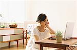 Young woman using PC in the living room