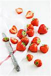 Strawberries, a tea towel and a knife